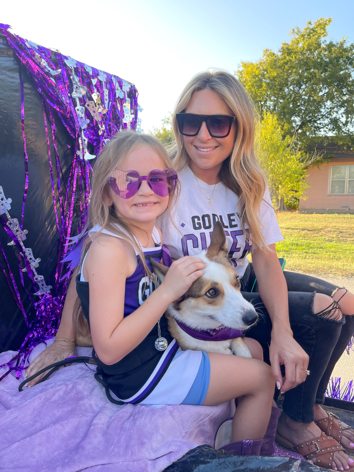 Mom, daughter and corgi dog on homecoming float.