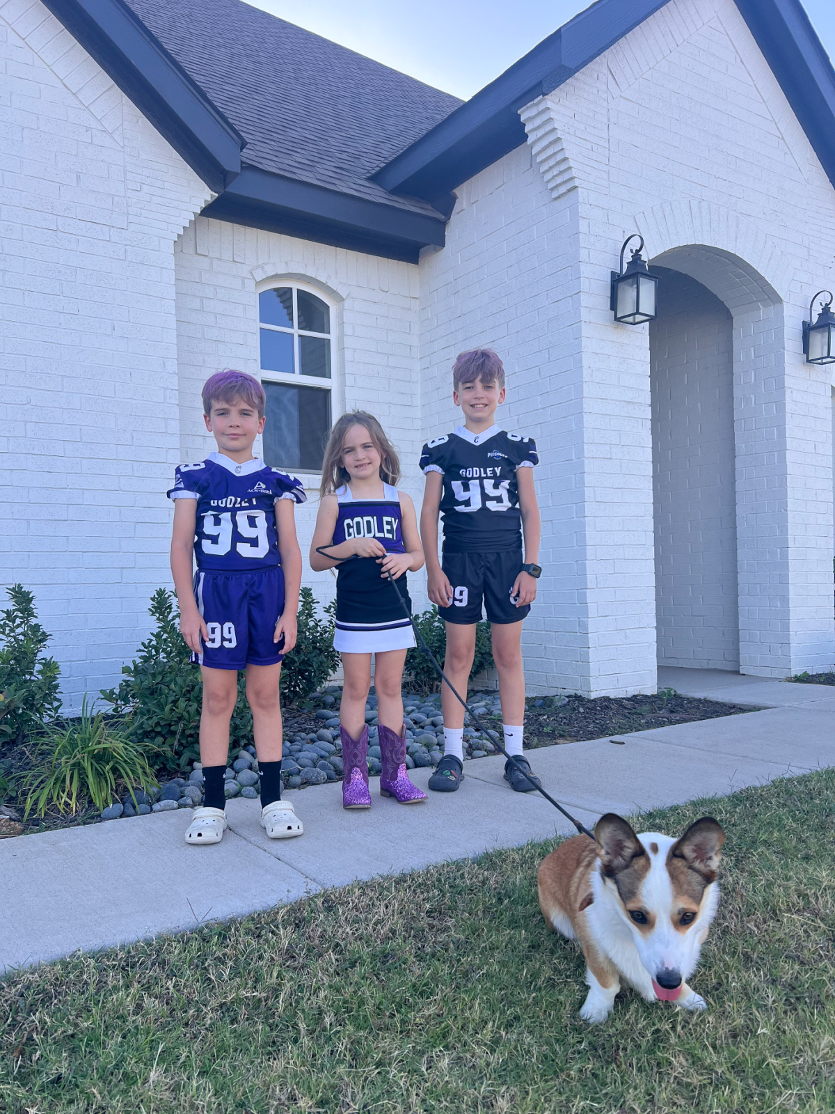Sister, brothers and their dog in front of their home in Texas.