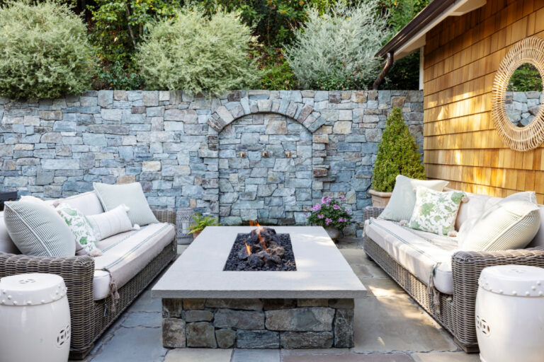 Back patio fireable, flanking sofas and water feature.