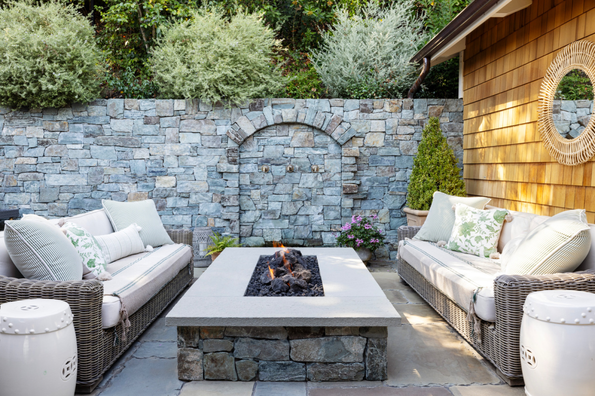 Back patio fireable, flanking sofas and water feature.