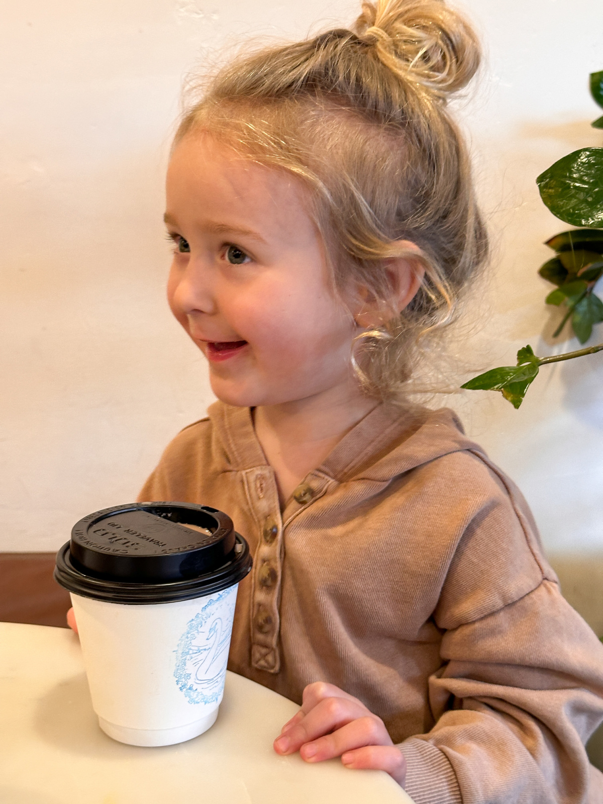 Little girls enjoying a hot chocolate.