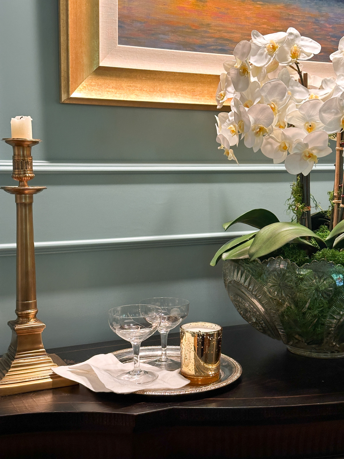 Martini glasses on silver tray alongside Hood Canal Candle Co.'s holiday candle.