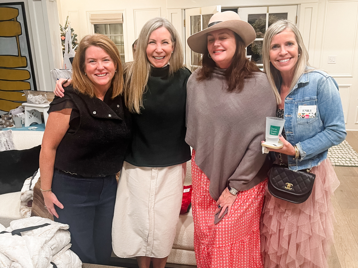Four women standing in holiday boutique.