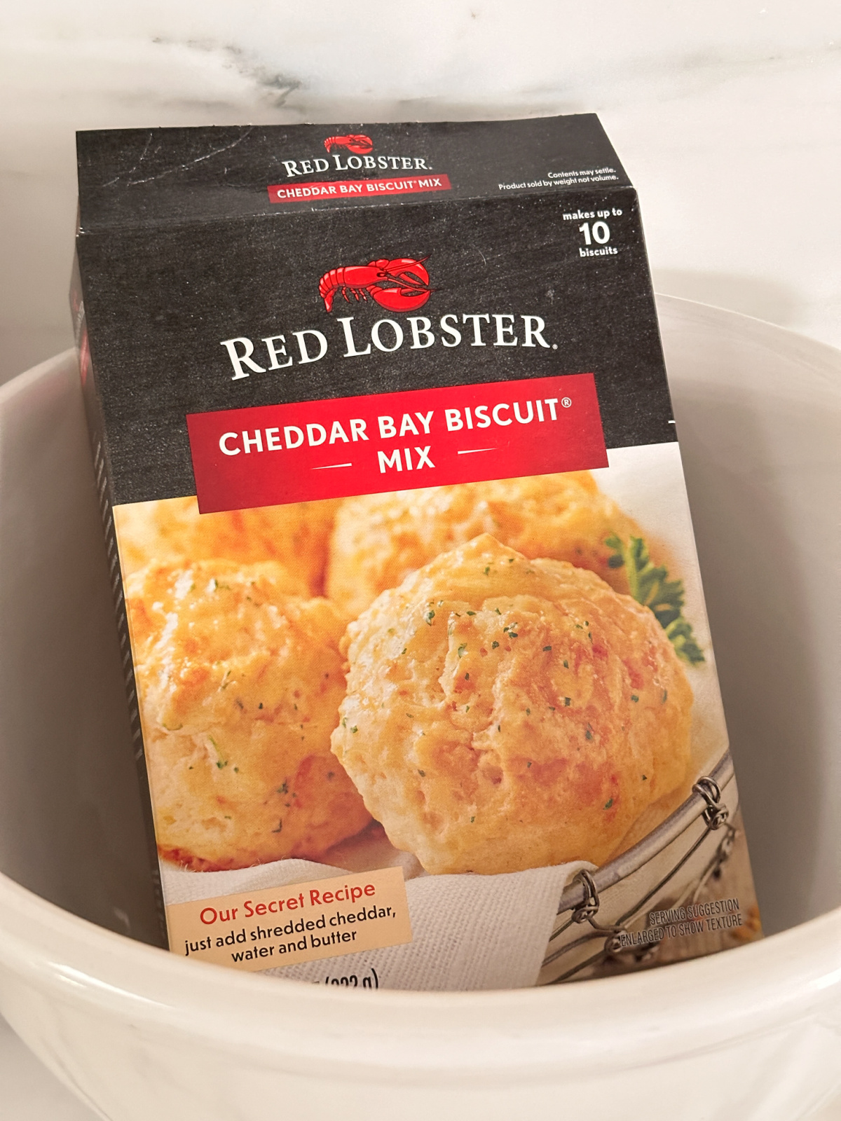 Box of Red Lobster Cheddar Bay Biscuit mix in bowl.