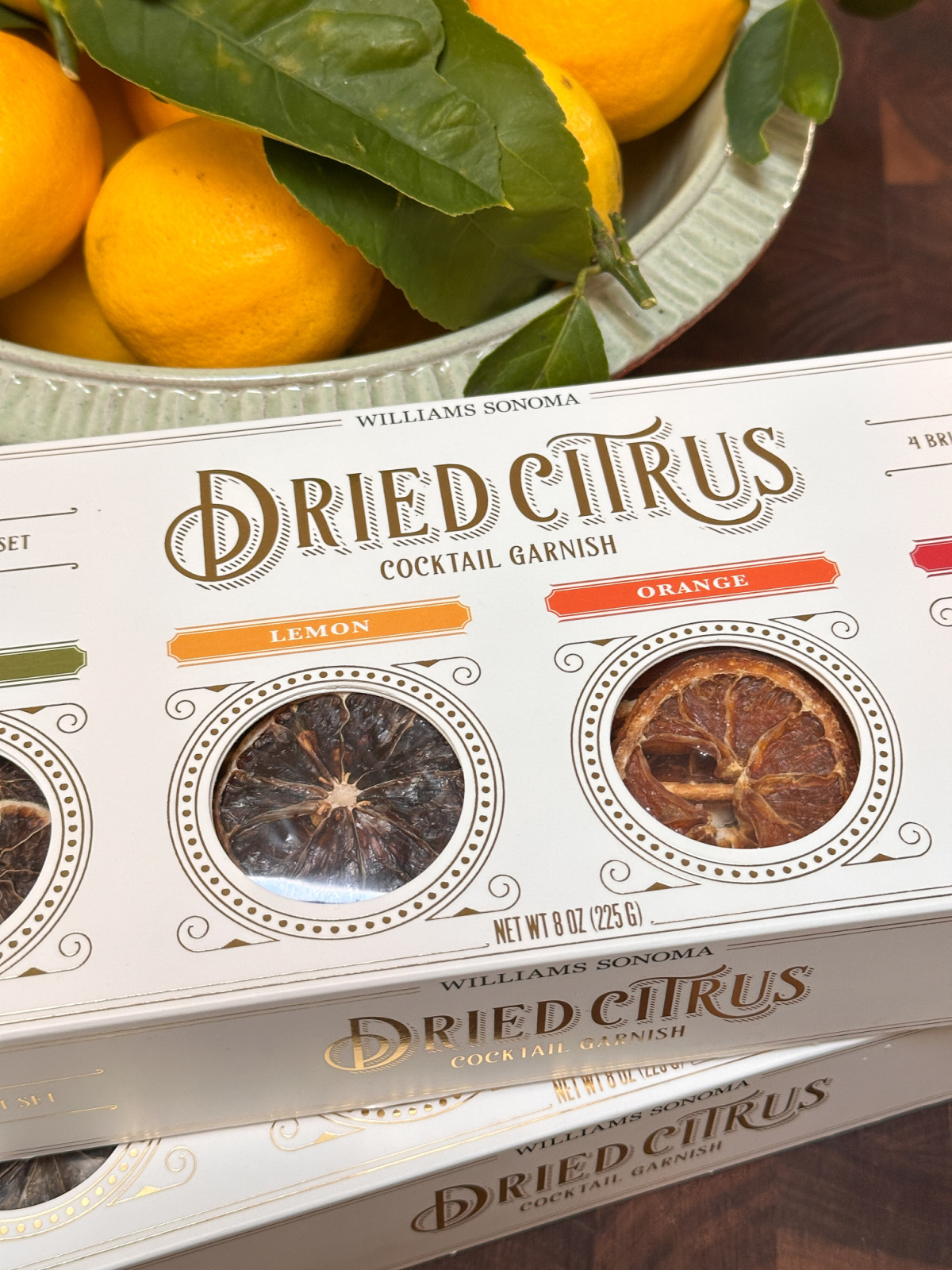 Boxes of dried citrus cocktail garnish and bowl of lemons.