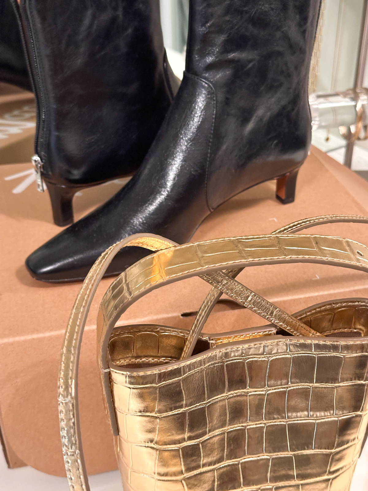 Metallic gold mini-bucket bag and low heeled booties.