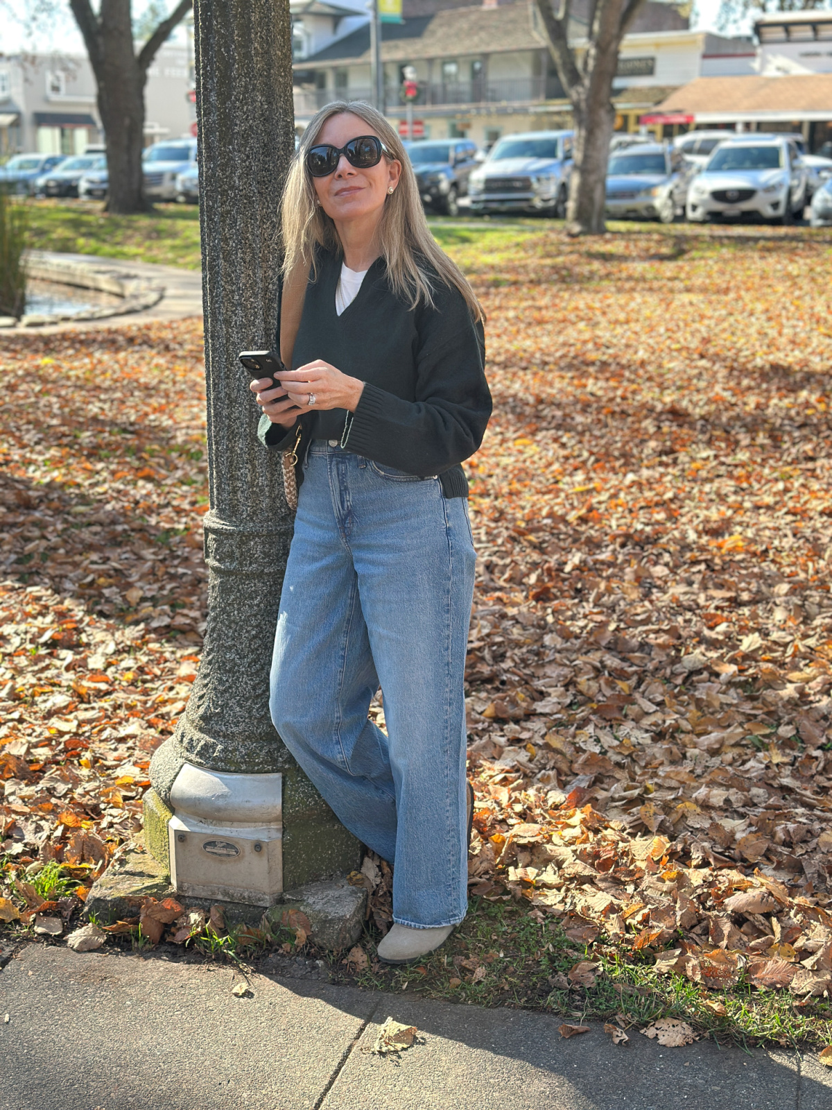 Woman wearing Madewell denim and sweater in Sonoma Plaza.