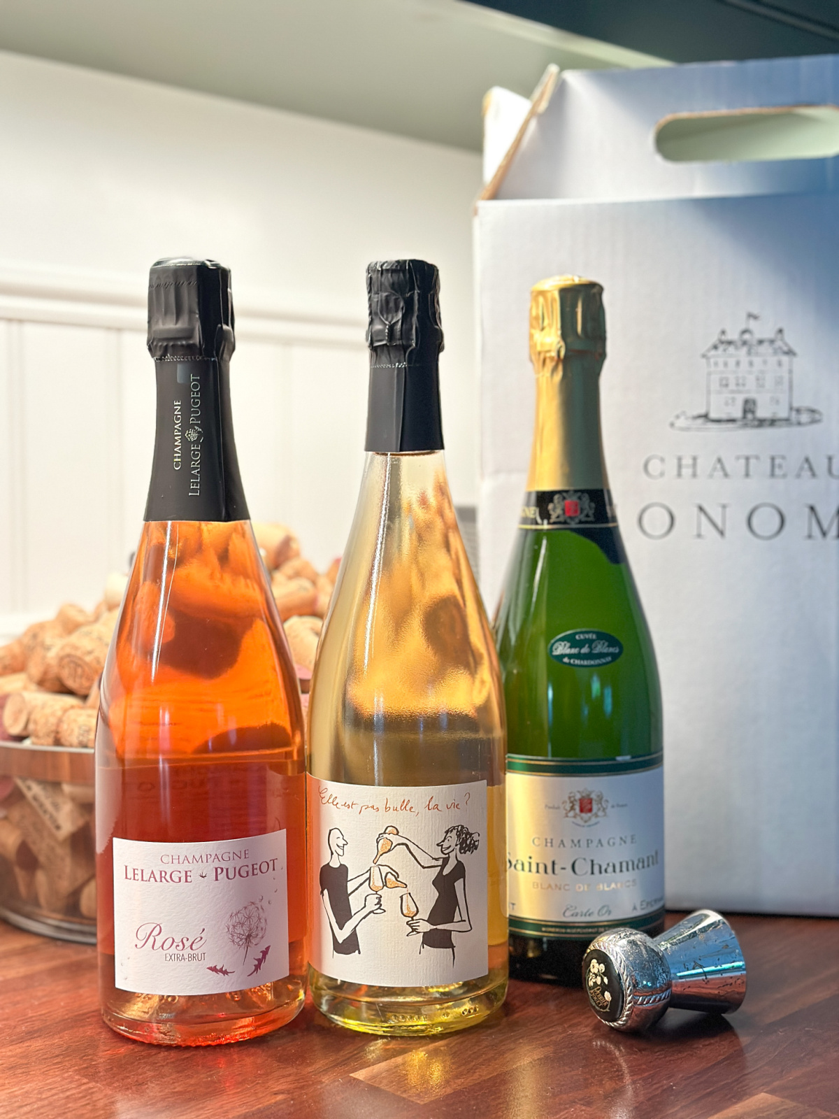 Three bottles of French champagne on bar counter.