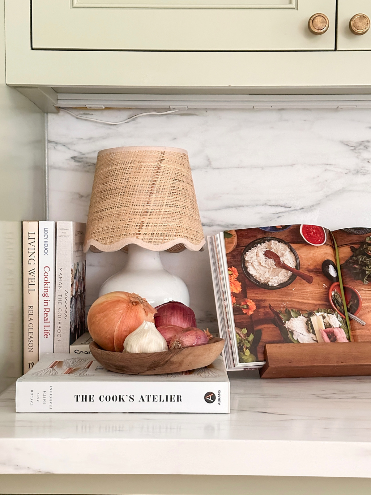 Cookbooks and lamp on kitchen counter.