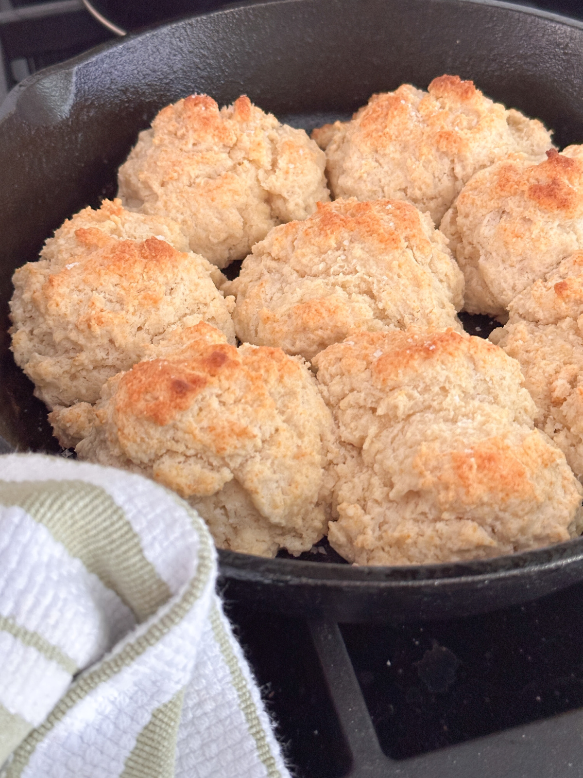 Cast iron pan full of drop biscuits.