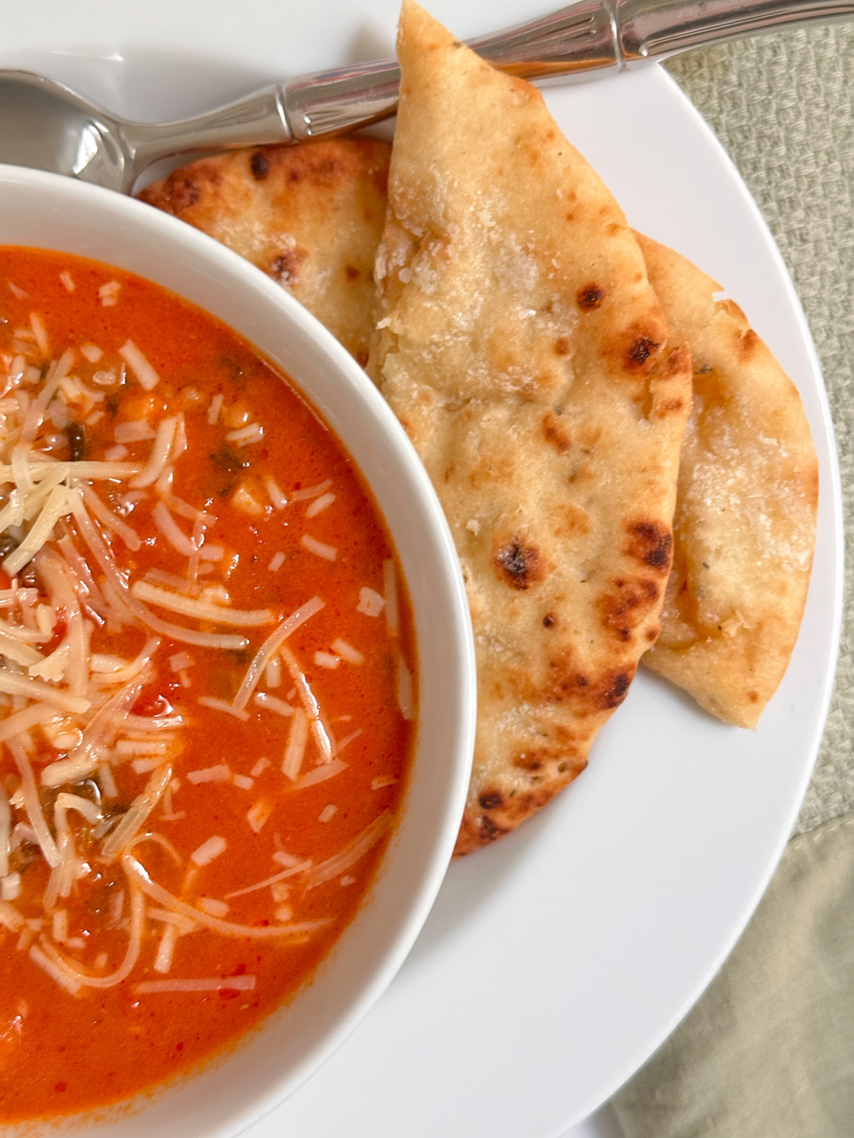 Bowl of Italian Sausage and Kale Soup with Tortellini and Nann Bread.