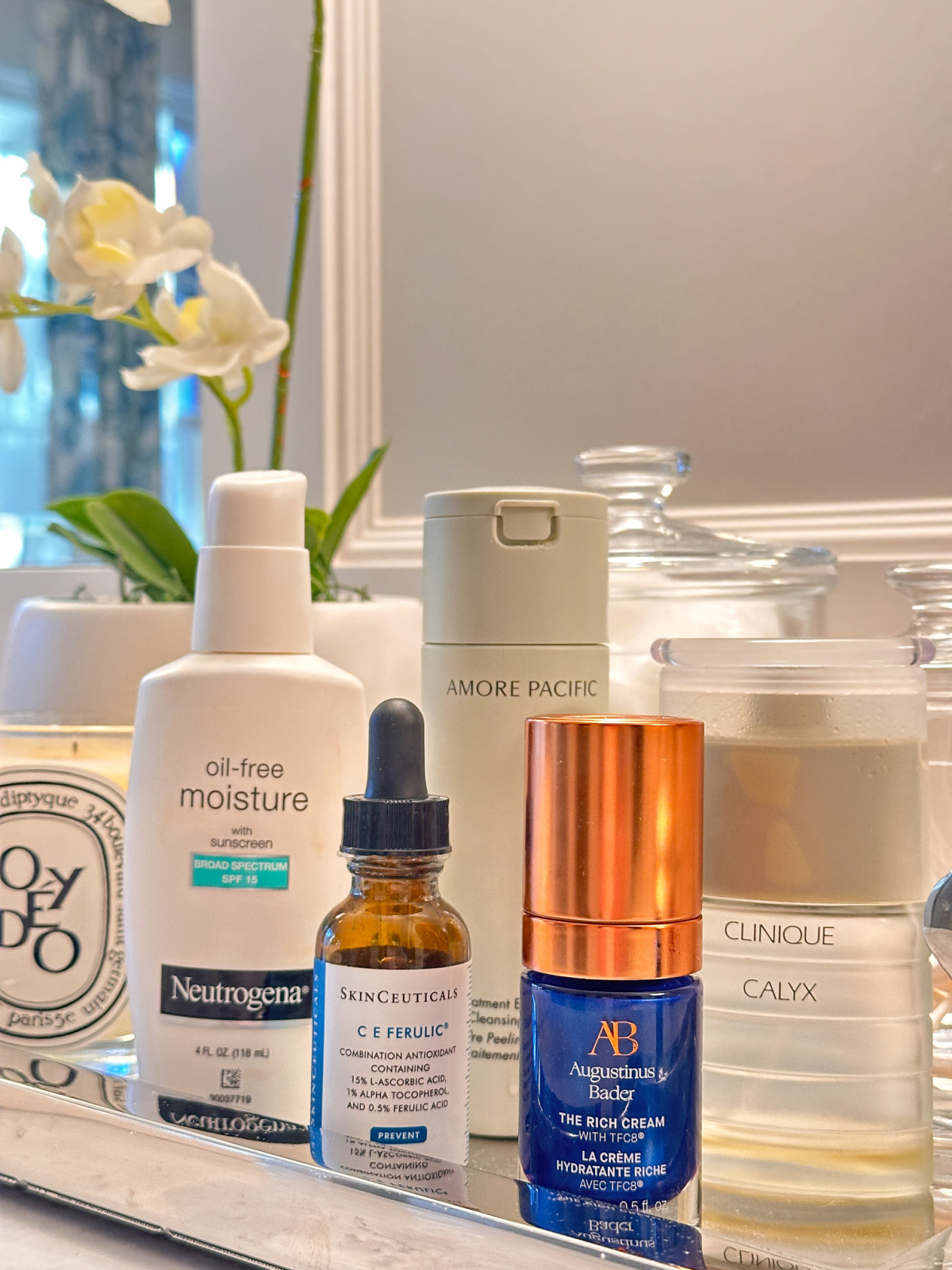 Bathroom vanity tray with skincare products.