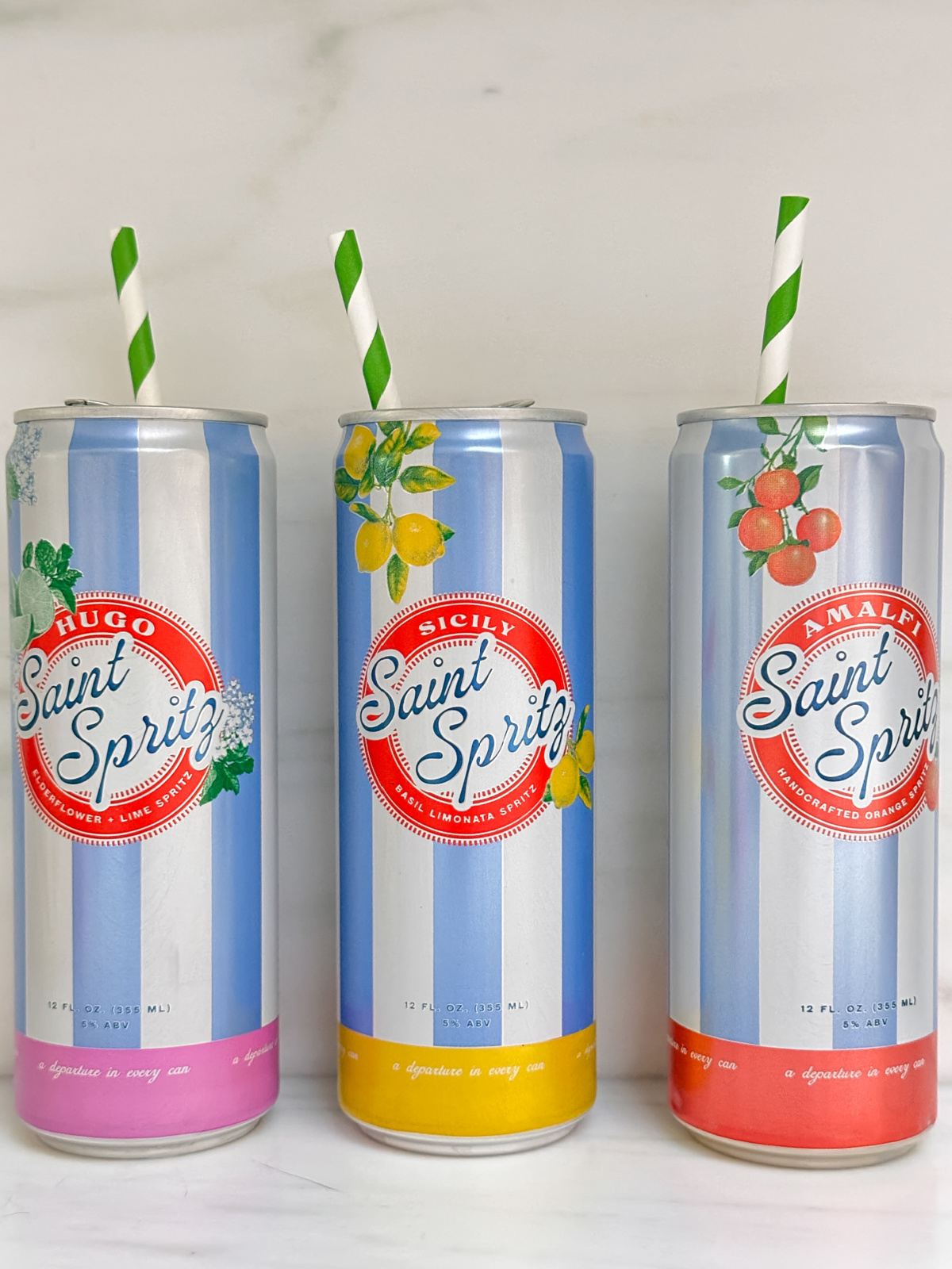 Cans of Saint Spritz with straws.