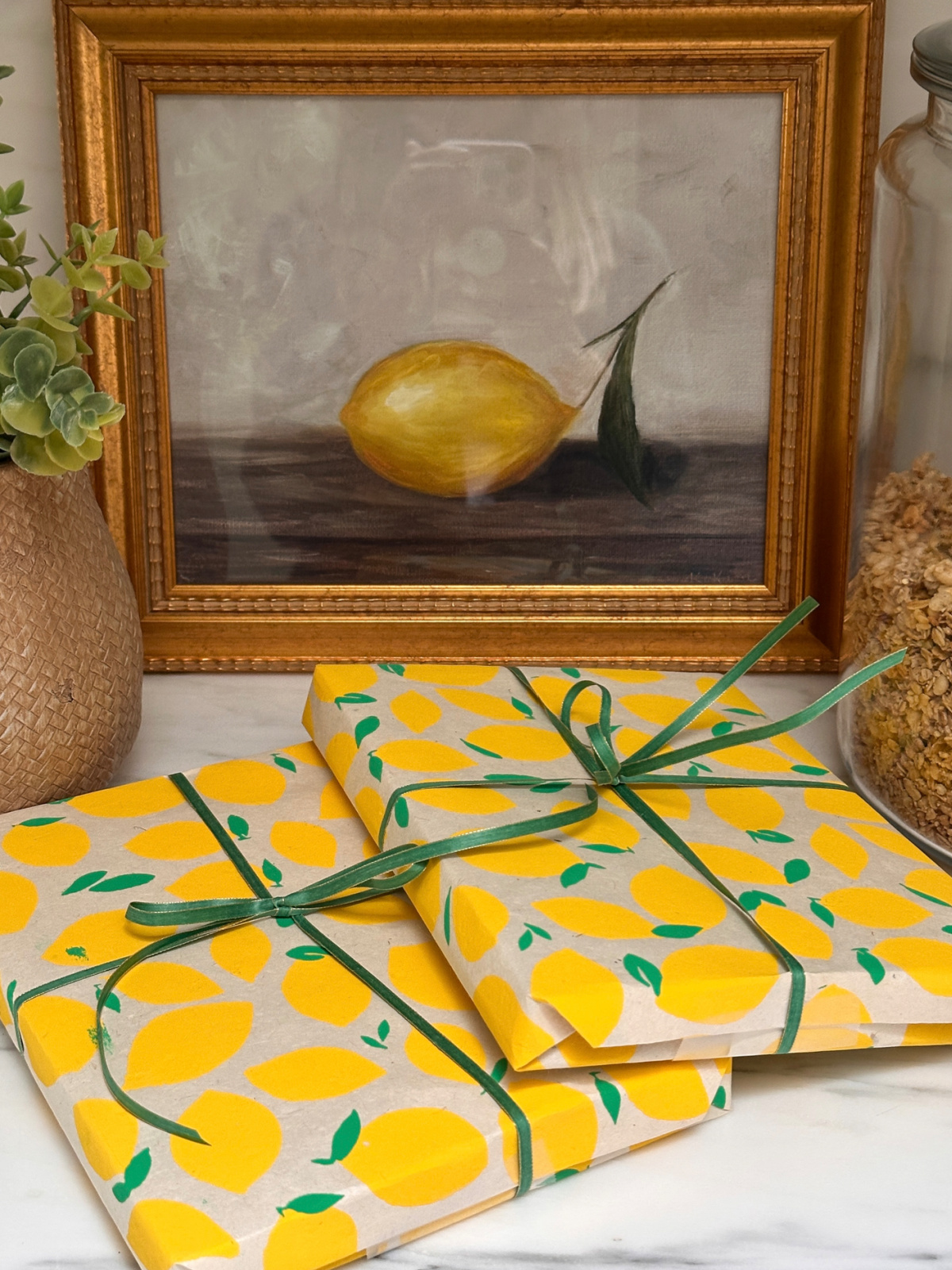 Books wrapped in lemon themed paper on kitchen counter.