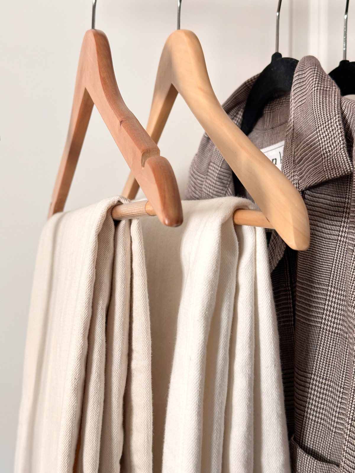 Warm White denim hanging on rack.