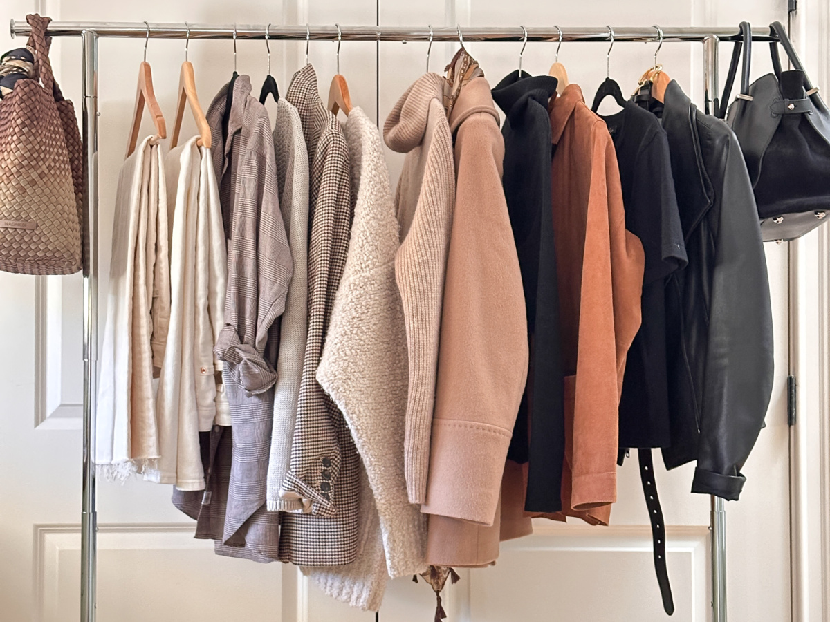 Rolling rack full of warm white denim styling capsule.