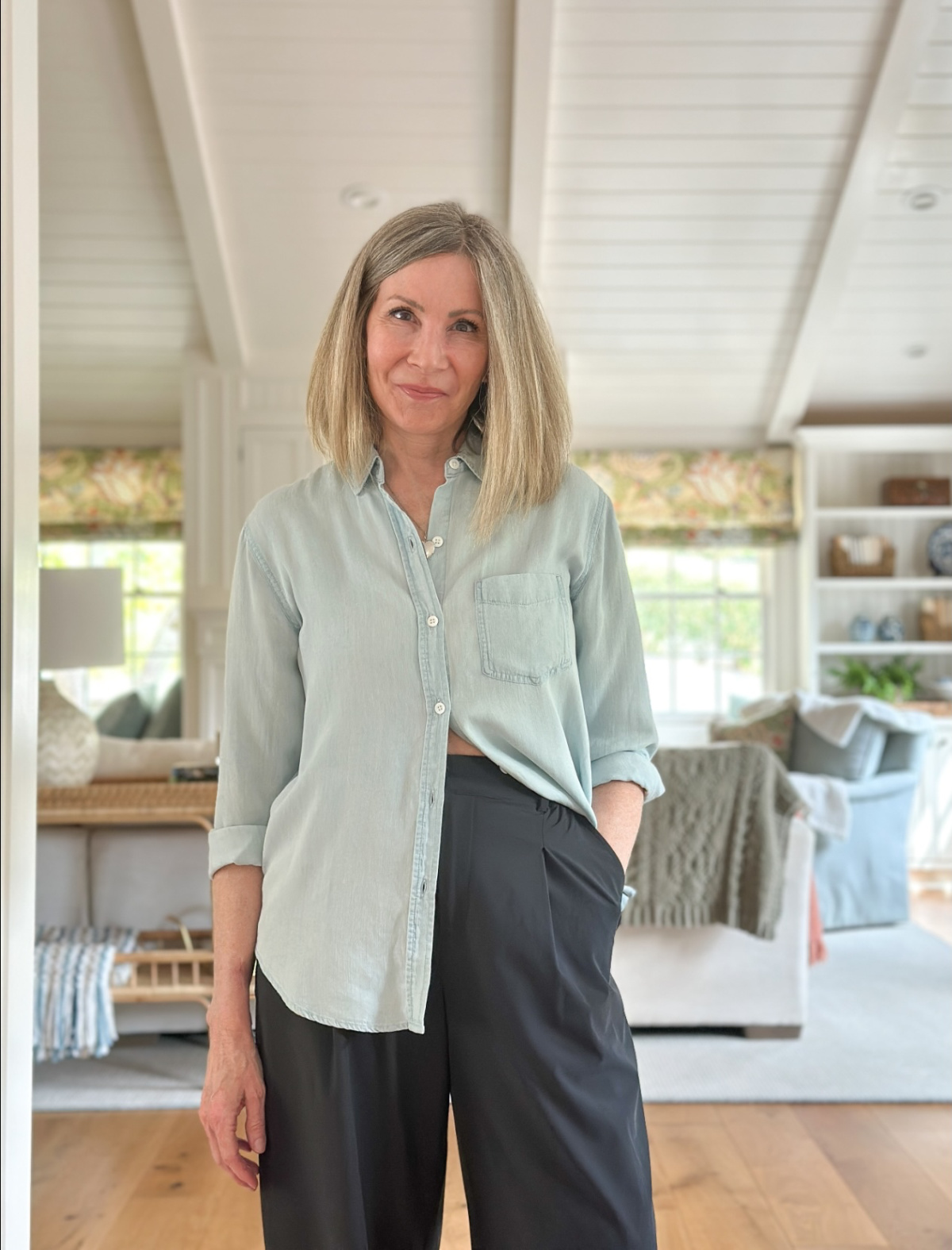 Woman wearing Rails chambray shirt and Alo black trousers.