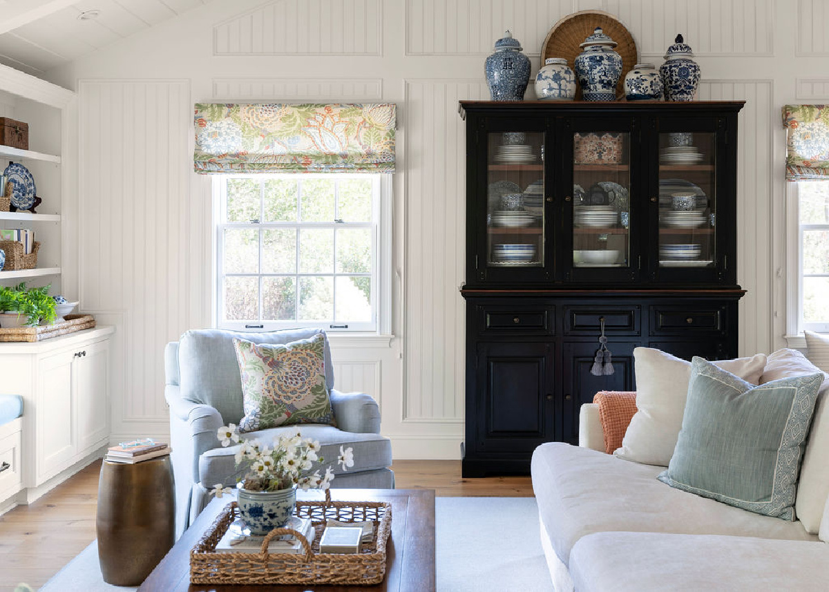 Black hutch filled with blue and white dishes.