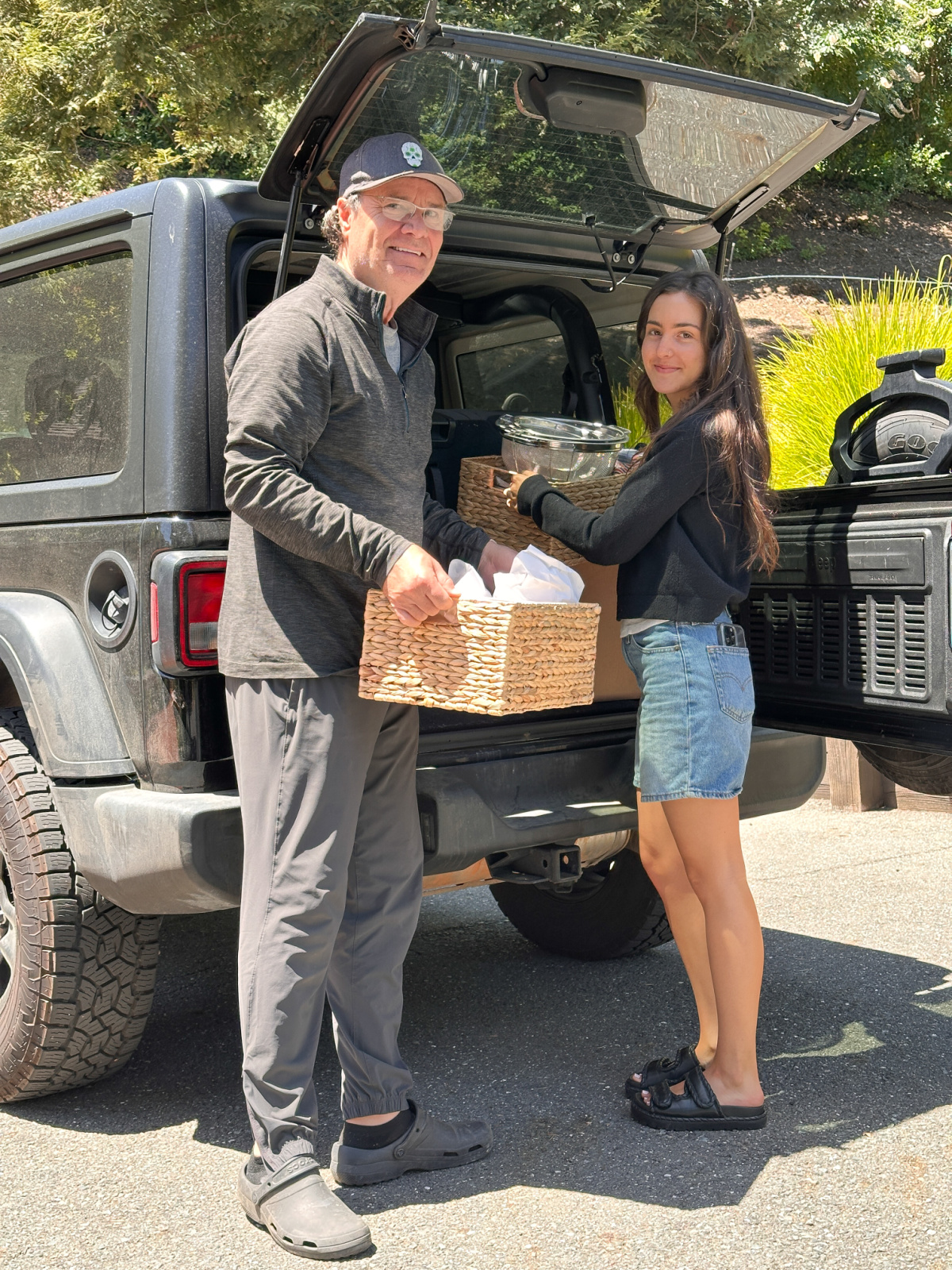 Man and his niece loading her car.