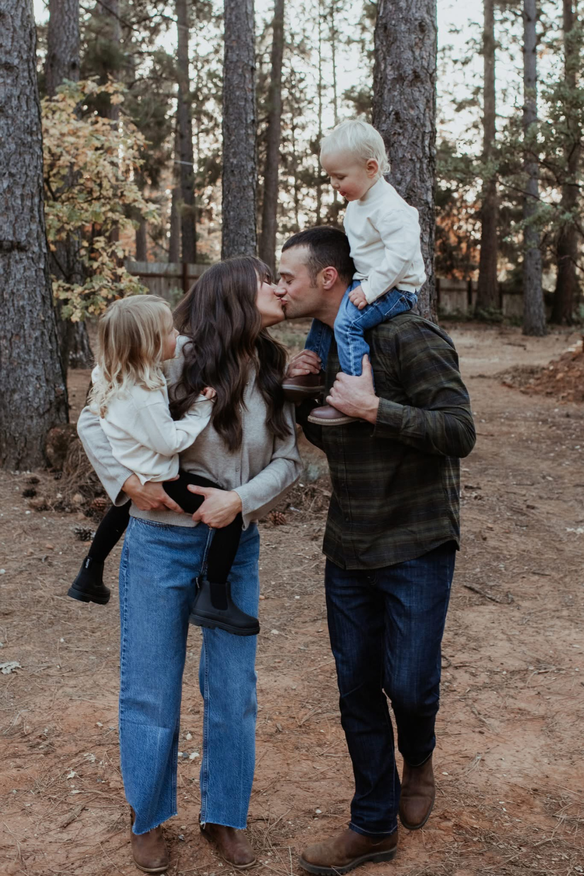 Family of four in the woods.