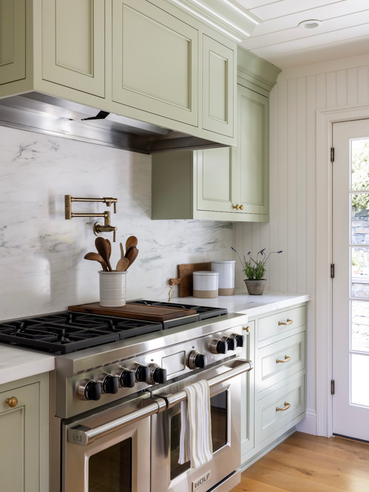 Green kitchen with Wolf range.