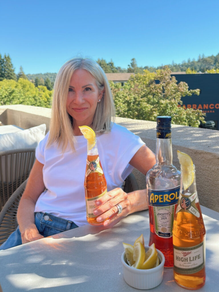 Woman holding Spaghatt Cocktail aka Trailer Park Spritz.