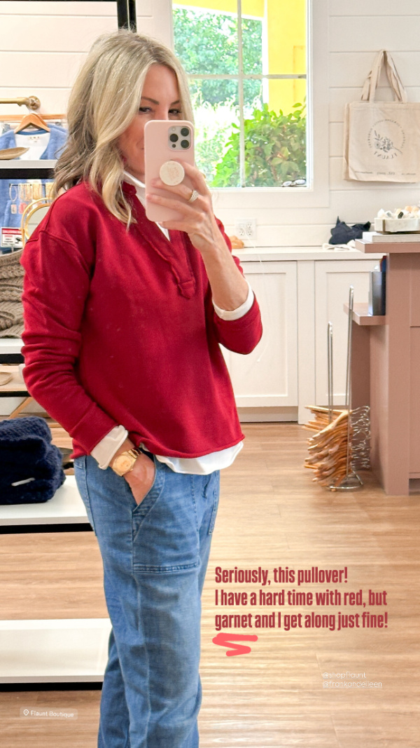 Woman taking mirror selfie wearing Frank & Eileen red sweatshirt.