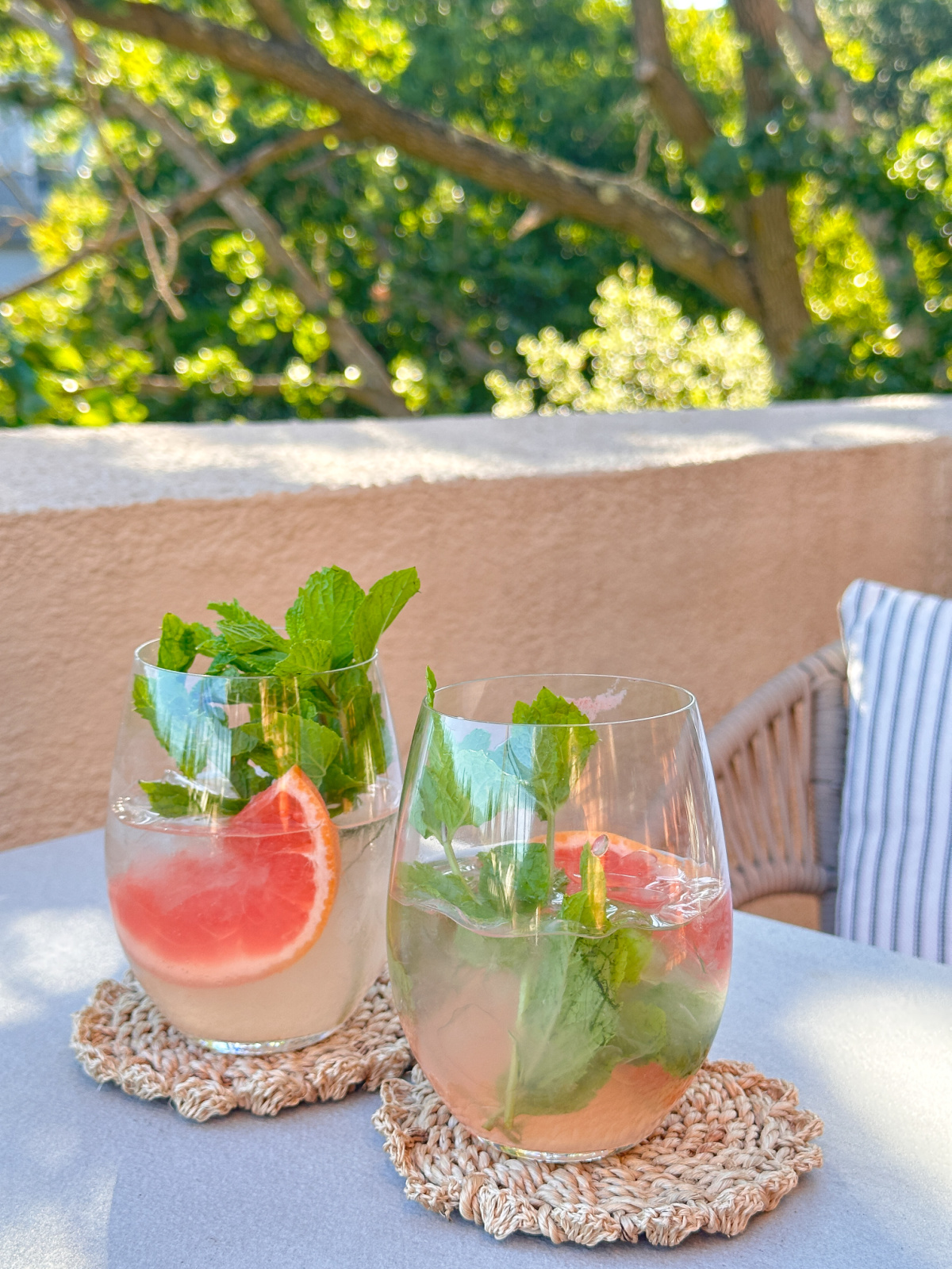 Two glasses of Hampton Spritzers on patio table.