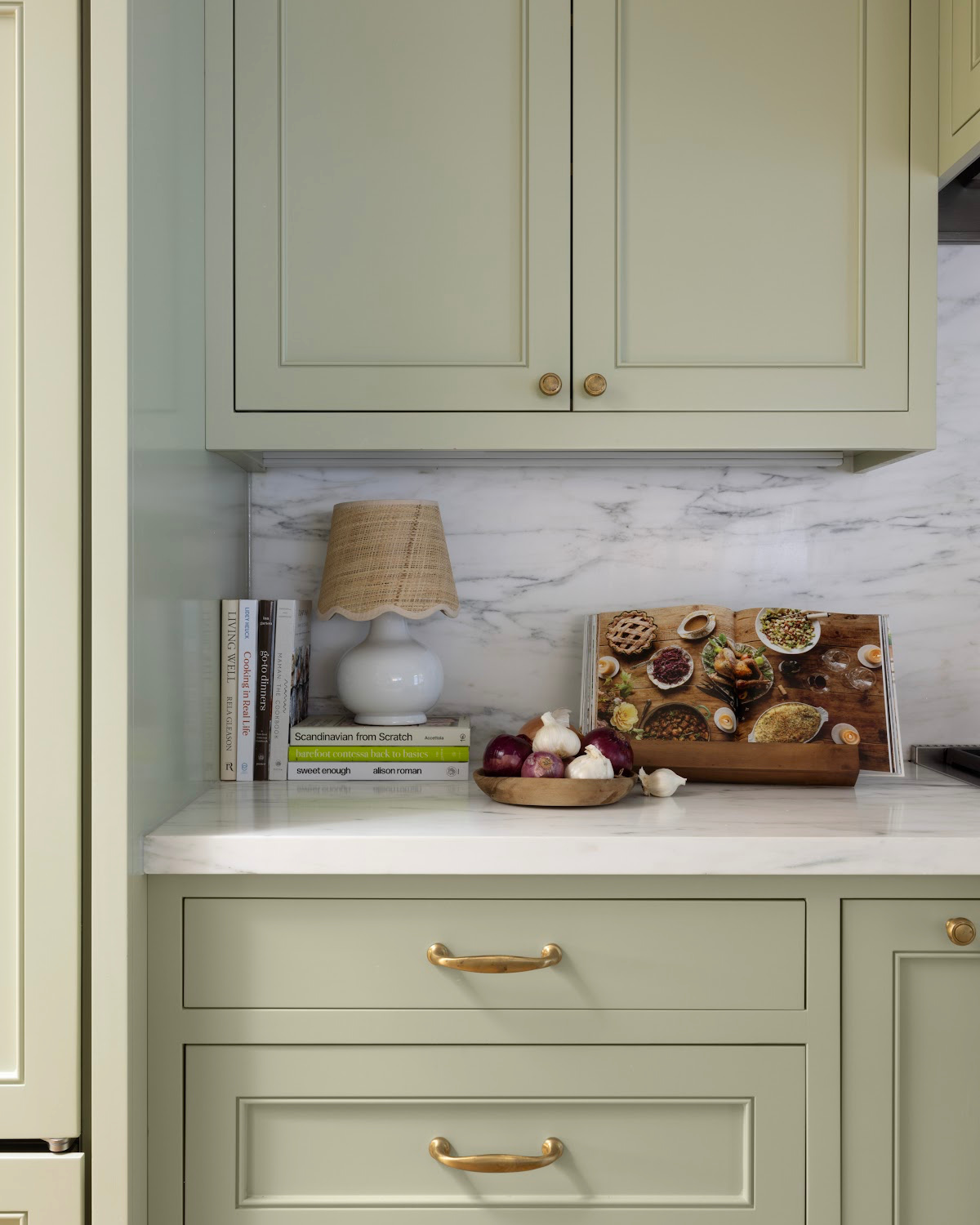 Green kitchen with small kitchen counter lamp.