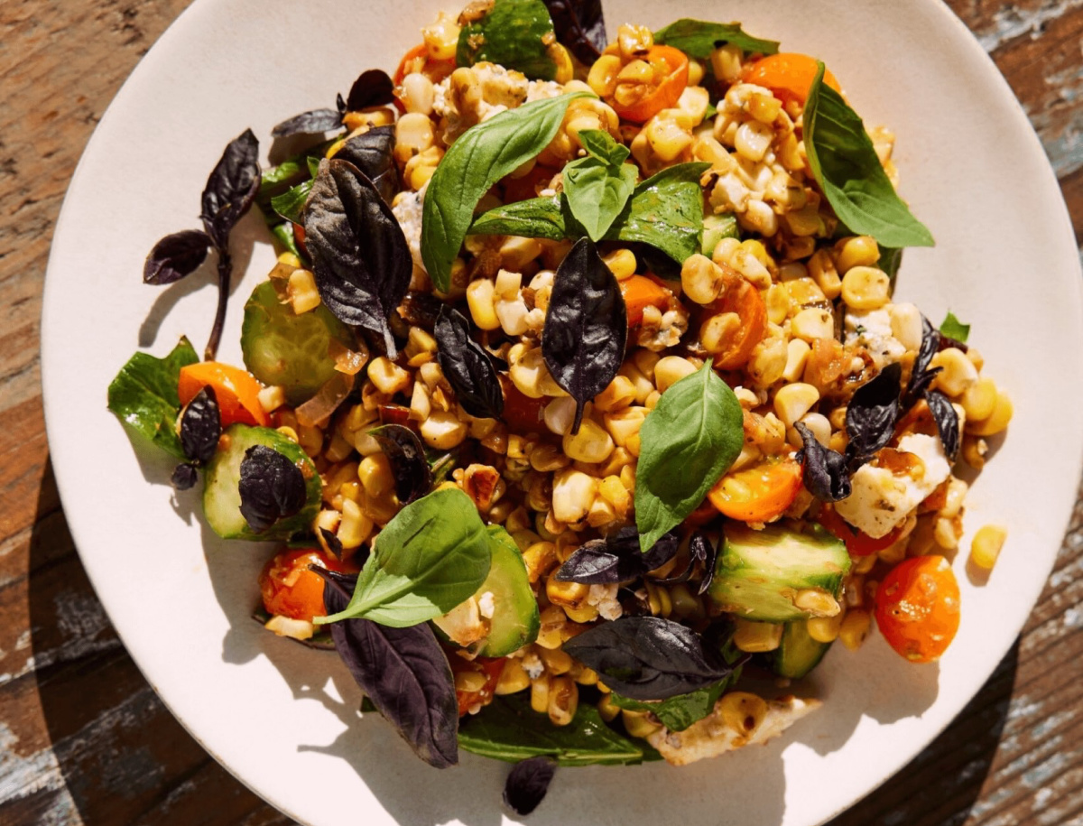 Bowl of roasted corn and smoked blue cheese salad from the cookbook Coastal by Scott Clark.
