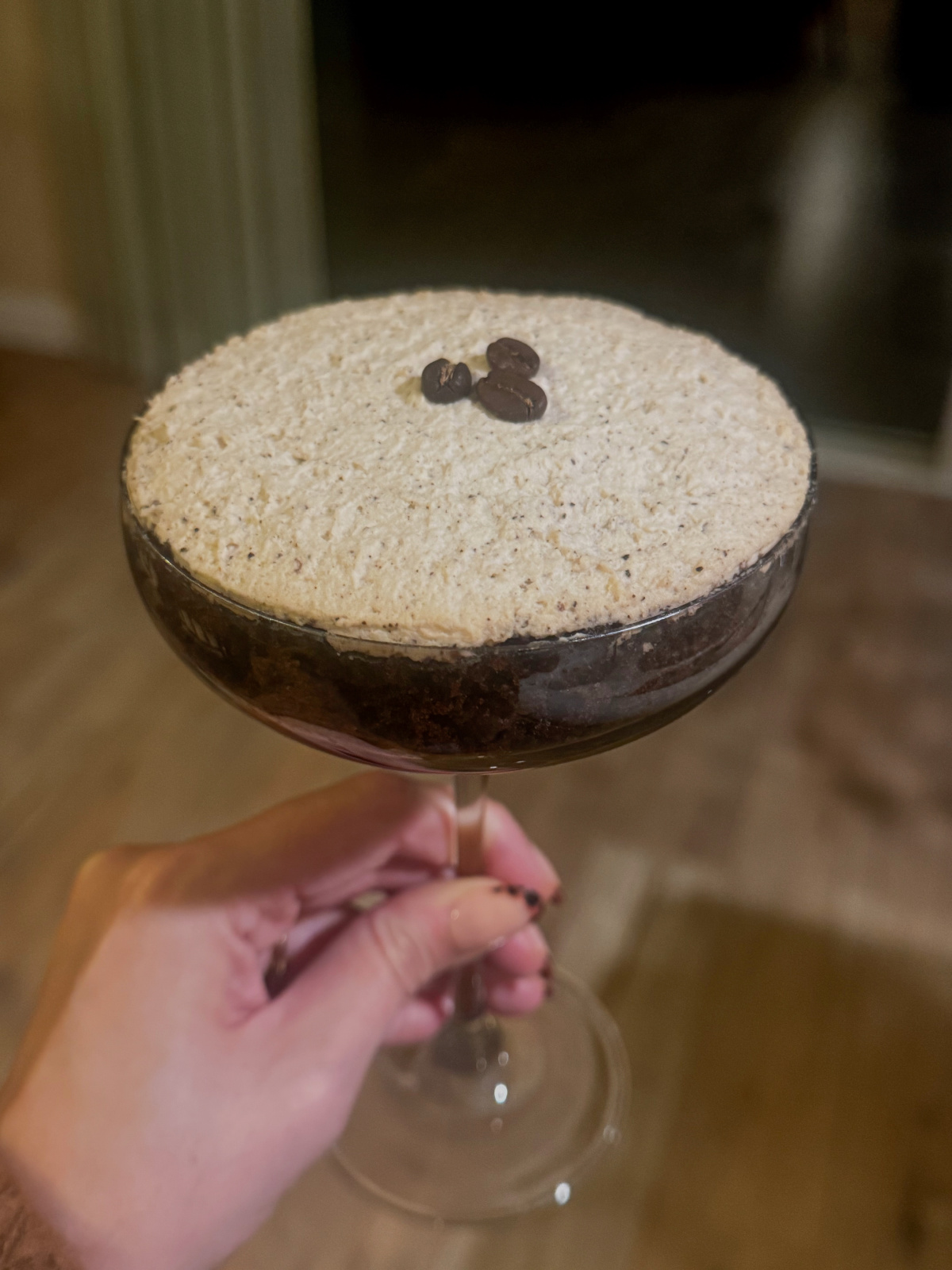 Coupe glass filled with chocolate espresso dessert.