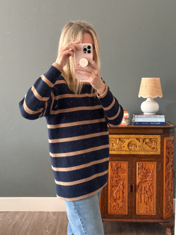 Woman taking mirror selfie wearing Boden's oversized Lucy striped sweater.