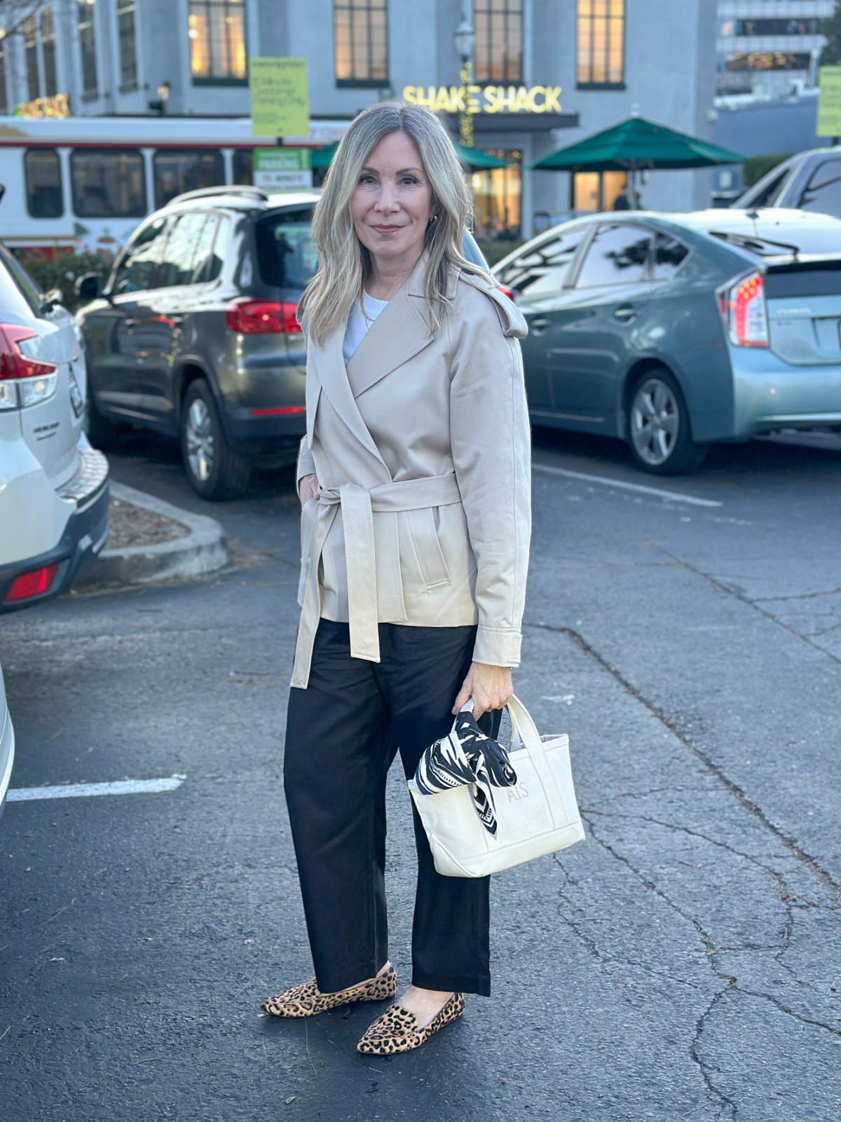 Woman wearing Madewell pants, and Artizia cropped trench.